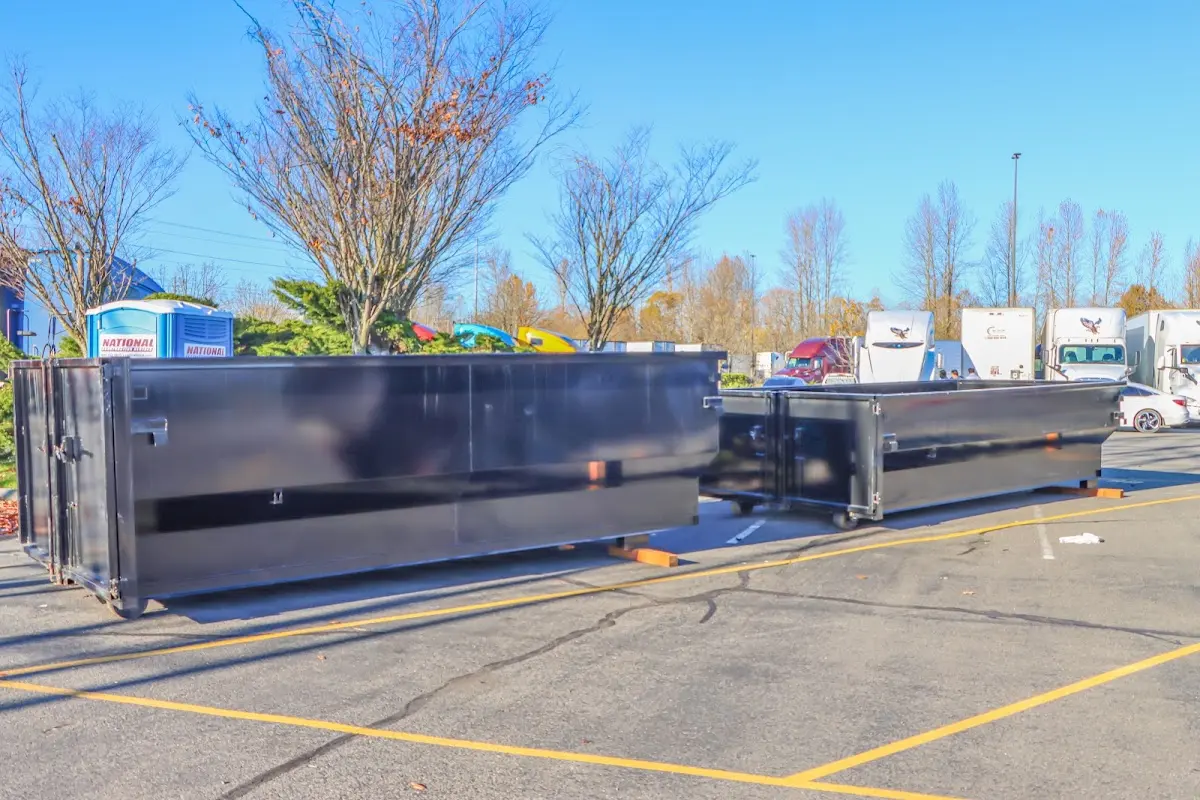 Professional dumpster rental service with roll-off container on residential driveway in Palmdale